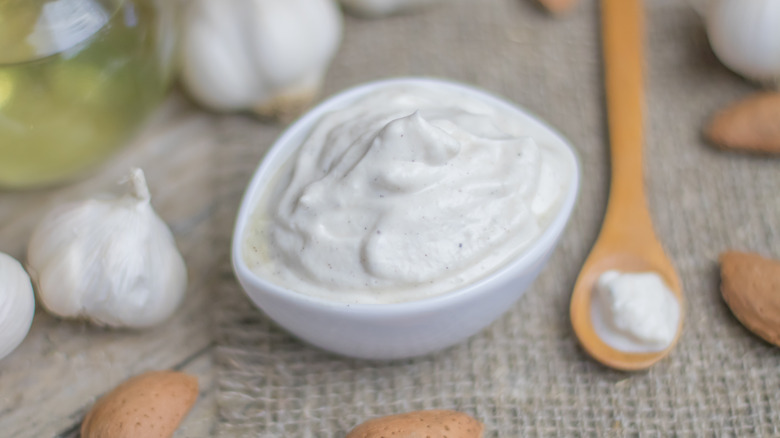 Homemade almond mayo with almonds in their shells