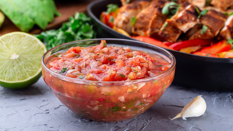 A bowl of fresh salsa served up with a beef or chicken dish