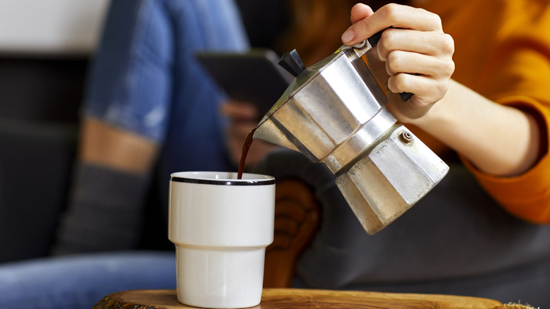 Coffee from moka pot into cup