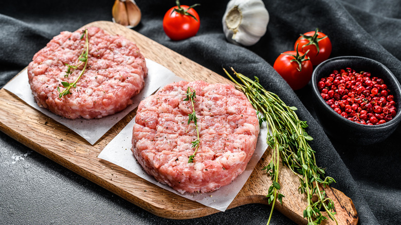 raw turkey patties on cutting board