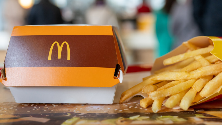 Big Mac Box with McDonald's logo and French fries in a McDonald's outlet.