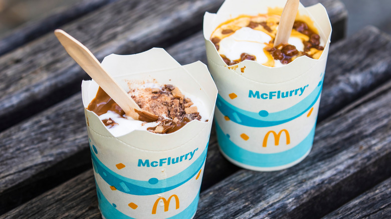 Two McFlurries with decadent toppings on a table