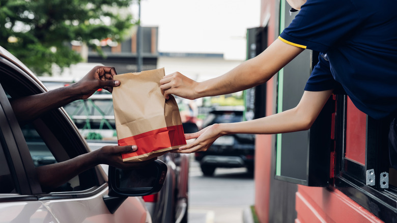 person receiving order in drive-thru