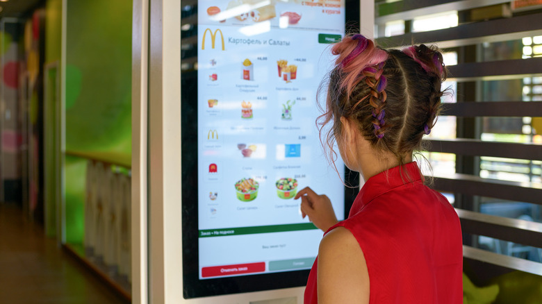 Person ordering McDonald's at kiosk