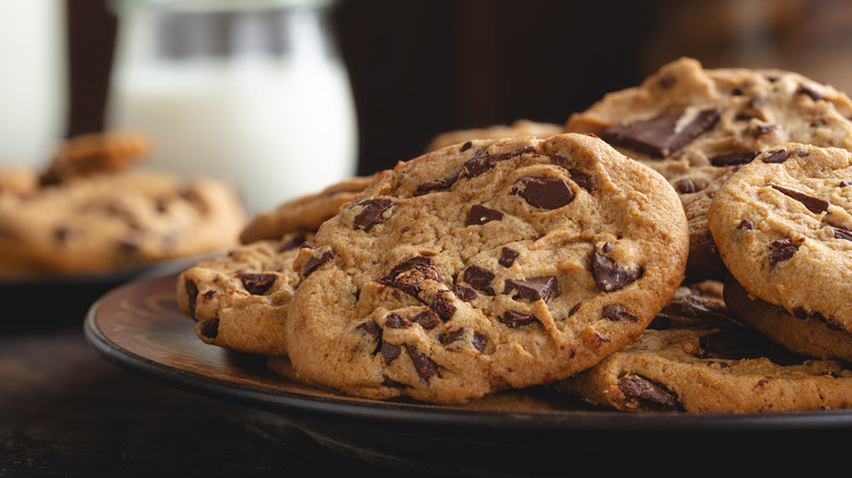 Chocolate chip cookies on a plate with milk
