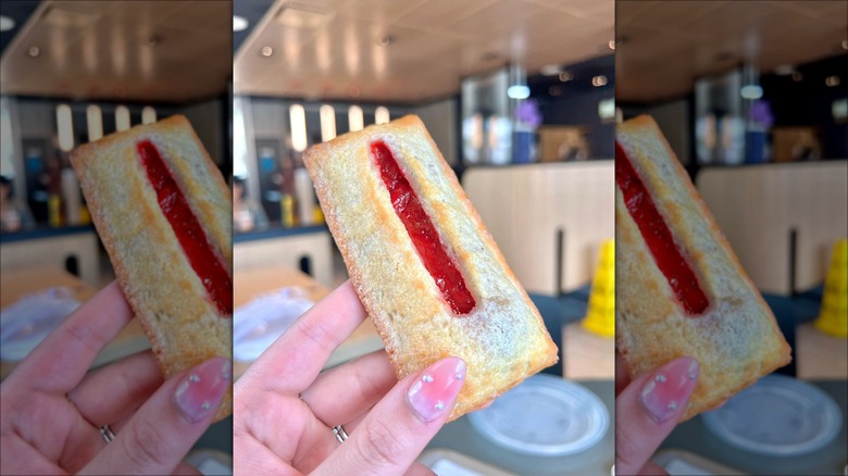 Person holding McDonald's Strawberry & Crème Pie