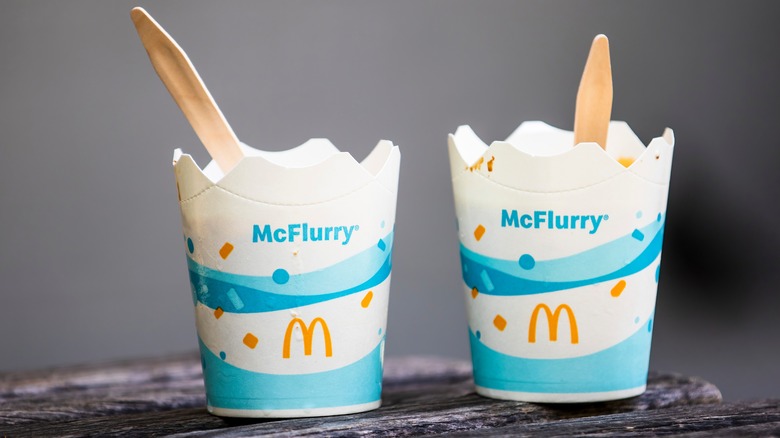 Two McDonald's McFlurry cups with wooden spoons