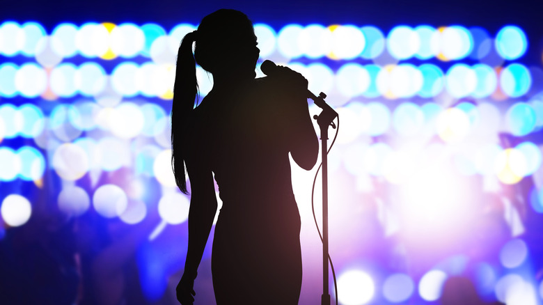 woman singing with microphone