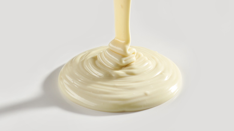 Melted white chocolate being drizzled