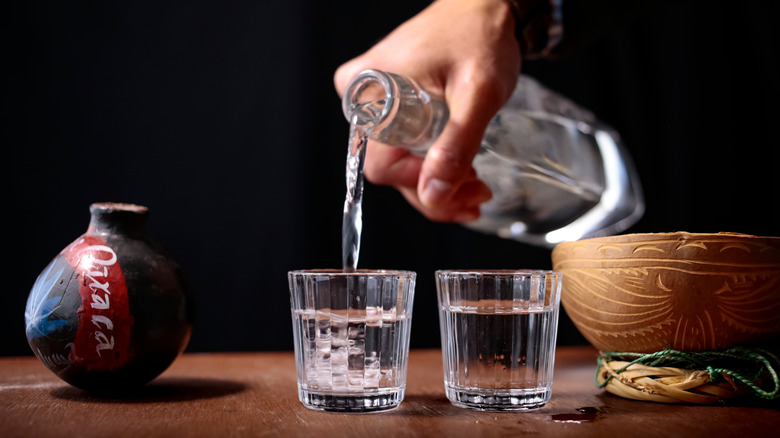 shots of clear liquor being poured