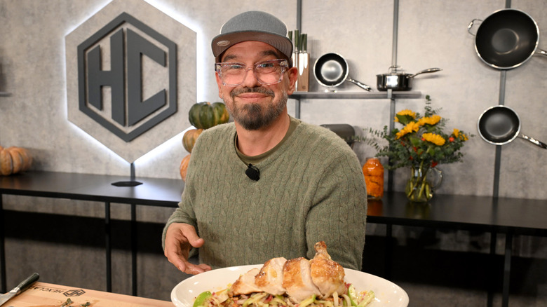 Michael Symon presenting a dish he made to the camera