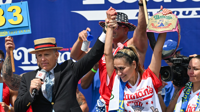 Miki Sudo holding championship belt