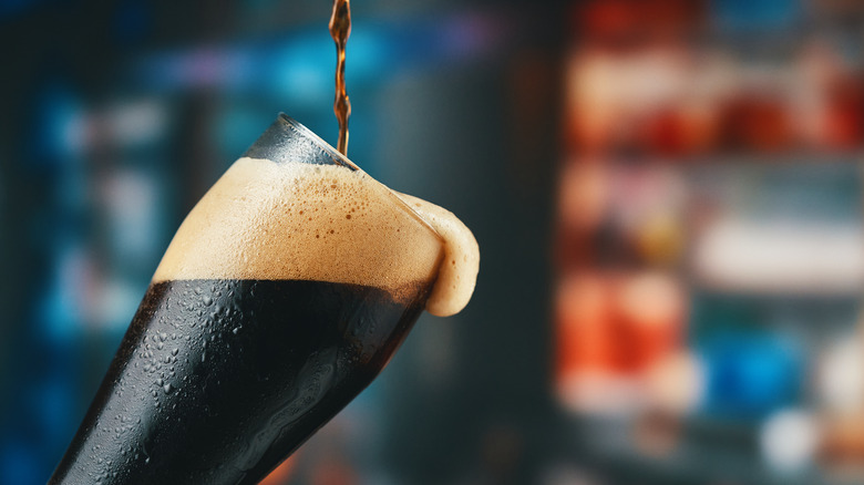 Pouring a dark beer