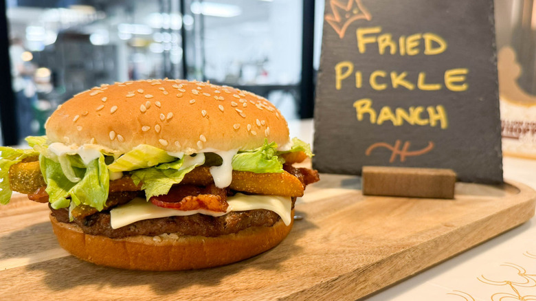 Burger King fried pickle ranch Whopper with sign