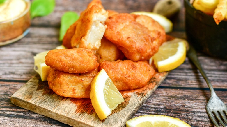 fried pollock pieces with lemon