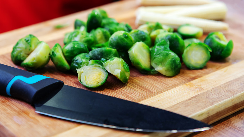 Halved Brussels sprouts on cutting board