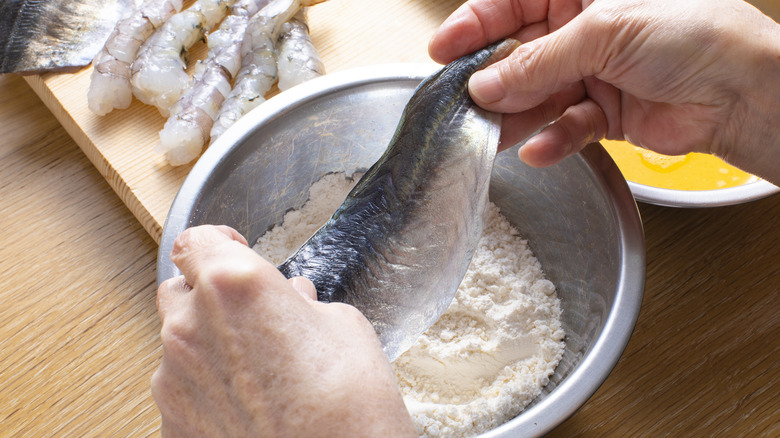 dredging fish filet in flour