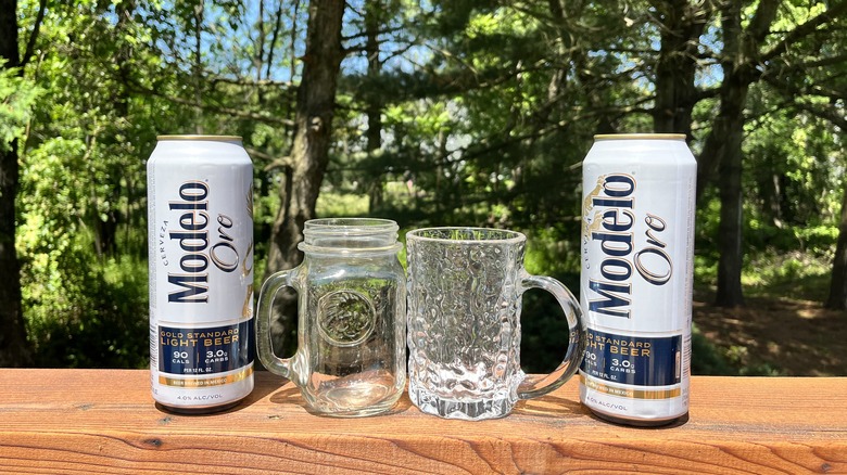 Two Modelo cans and mugs