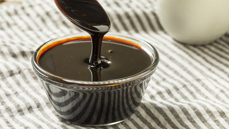 Dark molasses on spoon