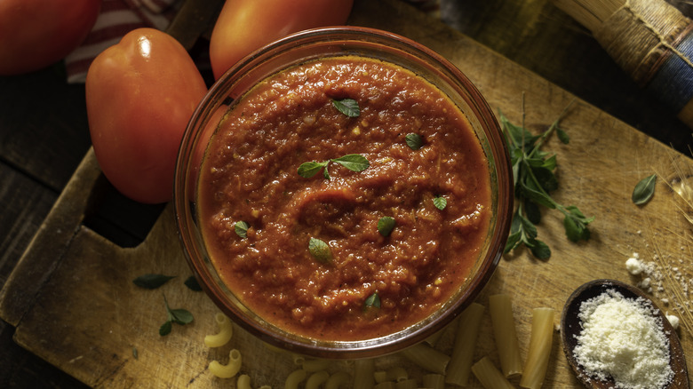 bowl of tomato sauce on chopping board