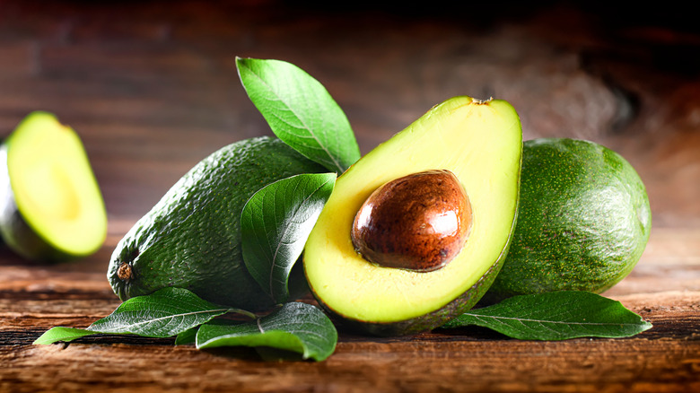 Avocados on wood background