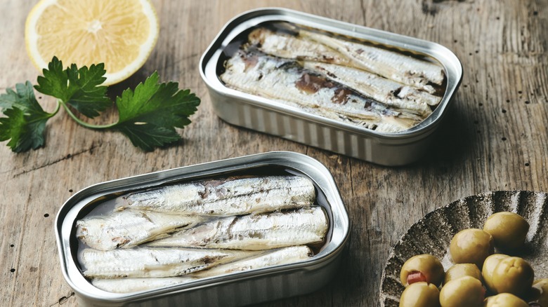 Cans of sardines on wood