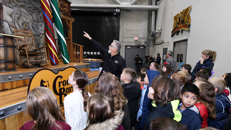 children viewing model of cracker barrel storefront