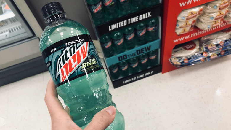 Bottle of Baja Blast held next to grocery display