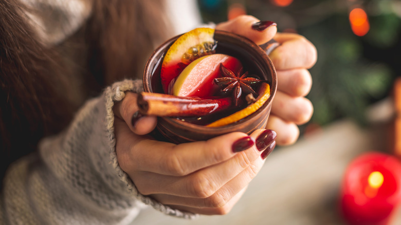 Hands holding mug of mulled wine