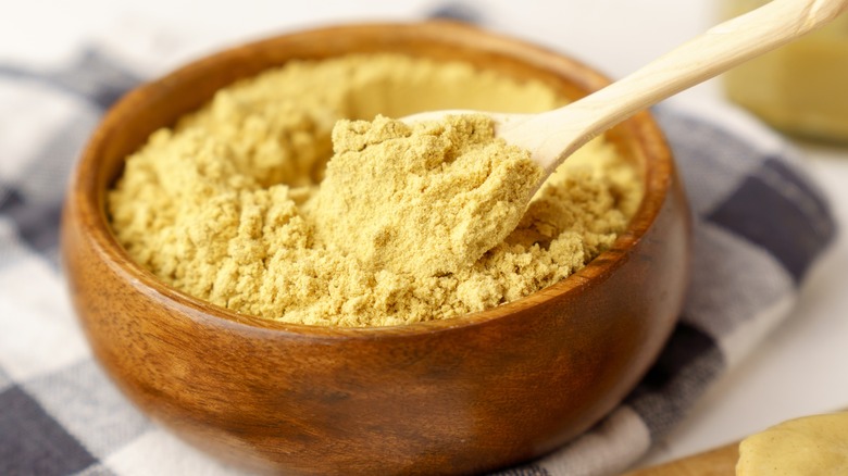 Mustard powder in a wooden bowl