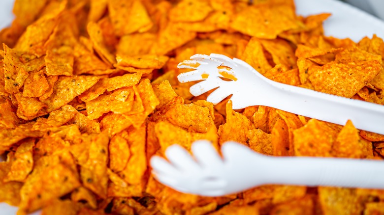 doritos in a bowl with serving utensil 