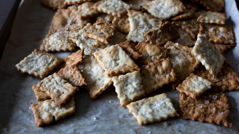 Pile of sourdough discard crackers on a baking sheet