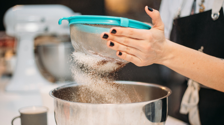 Sifting flour into a bowl