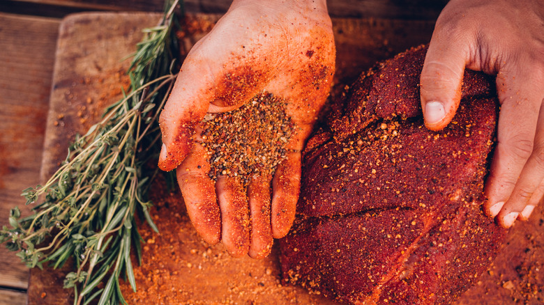 rubbing meat with spice rub