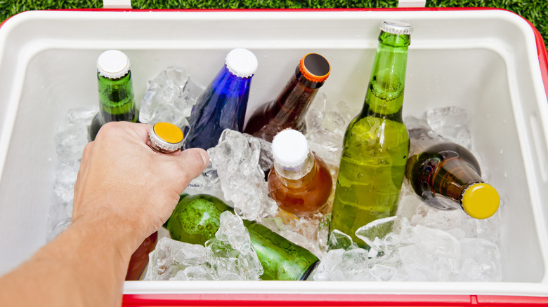 hand grabbing drink from cooler