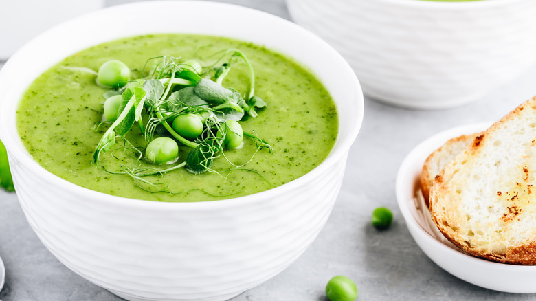 creamy pea soup in white bowl 