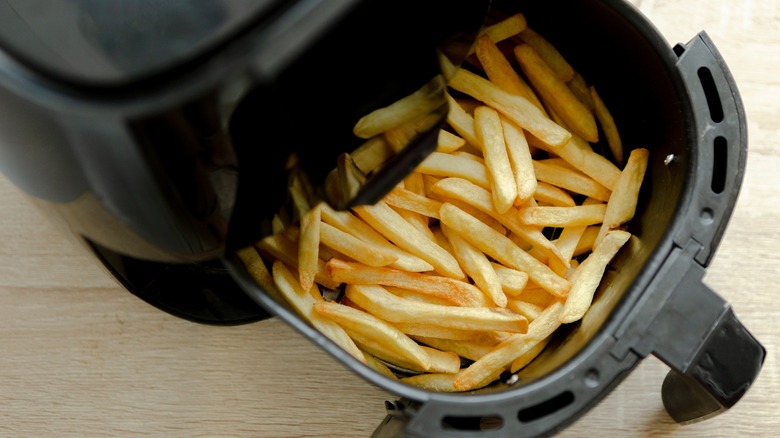 french fries and salt falling onto a table