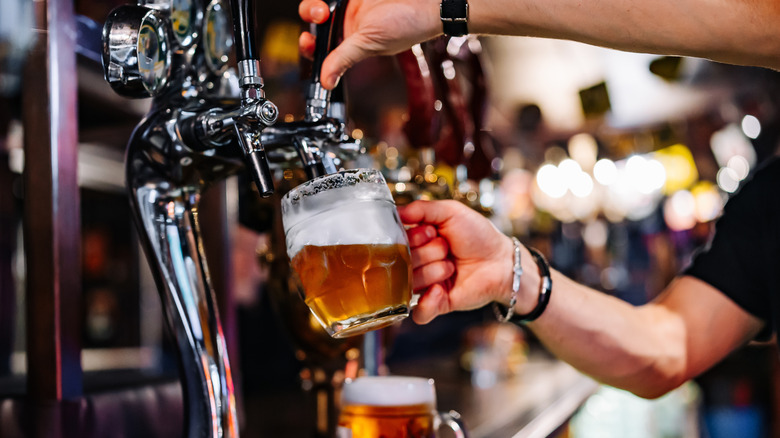 Bartender pouring beer from a tap