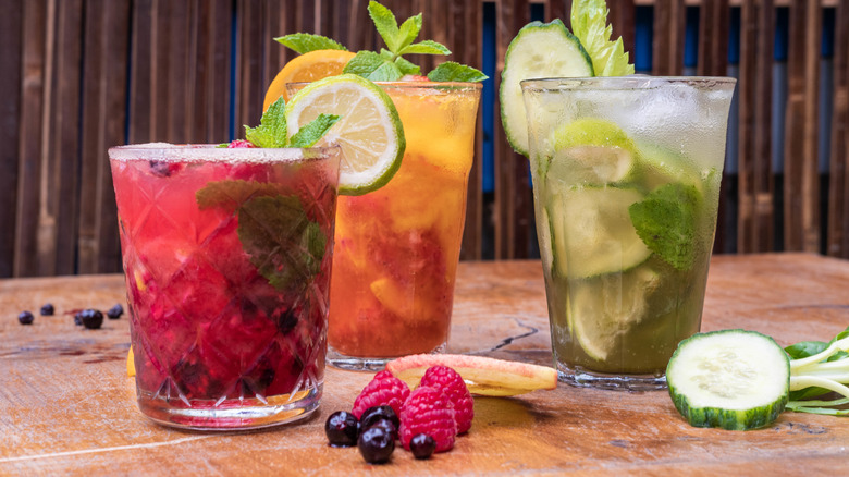 three colorful mocktails with garnishes