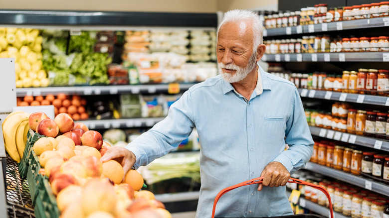 elderly gentleman shopping in the produce aisle