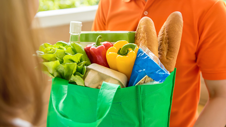 Person delivering a bag of groceries