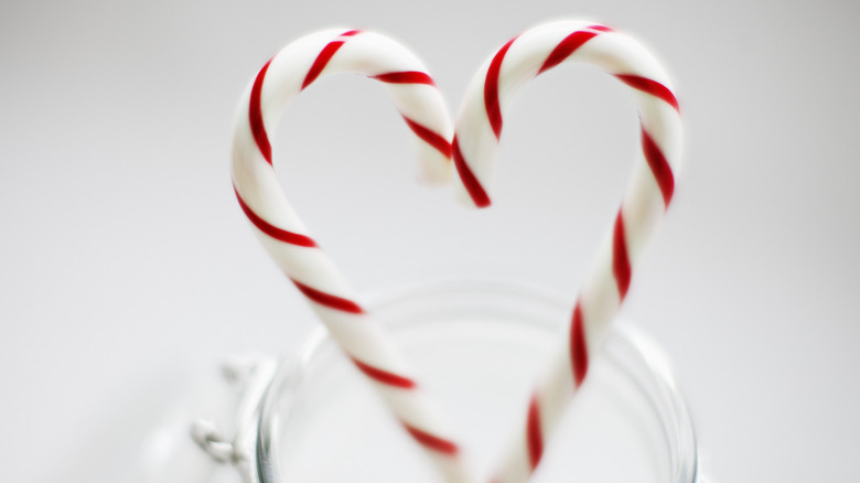 Two peppermint candy canes forming a heart