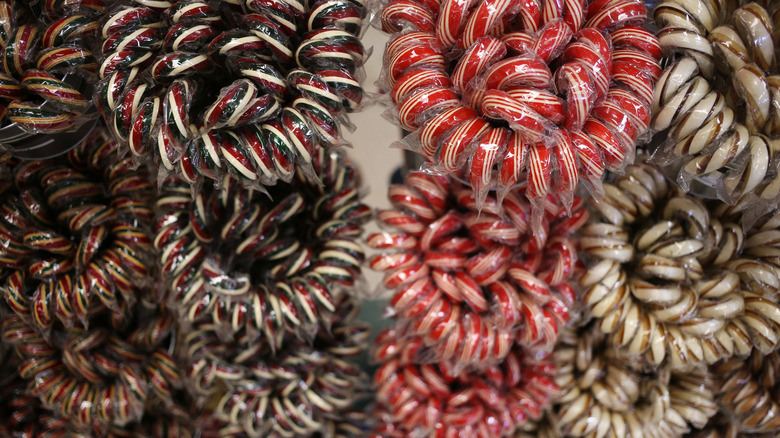 Four flavors of candy canes in bins for sale