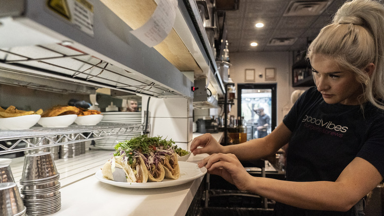 restaurant server getting food from kitchen