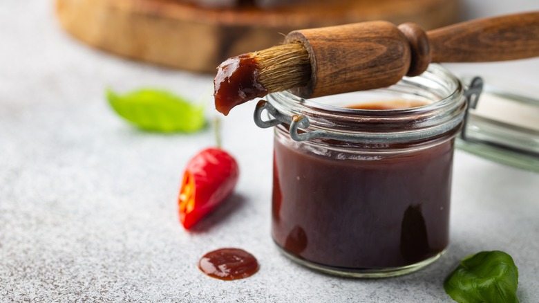 Basting brush dipped in barbecue sauce