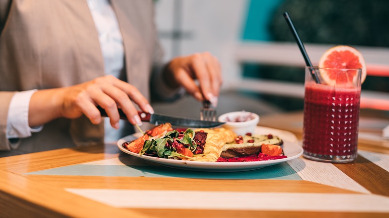 diner cutting up plated meal