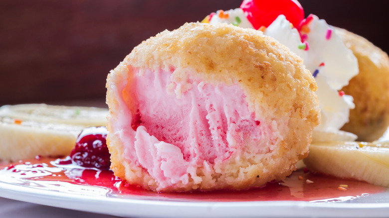 Fried strawberry ice cream in sauce on a plate