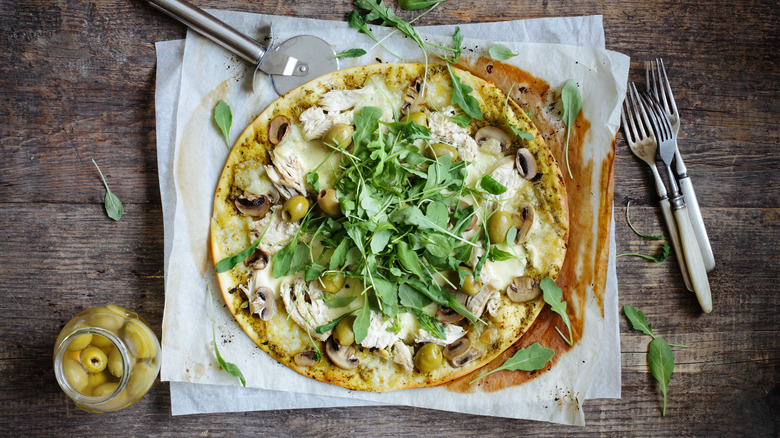 Salad and olives on pizza