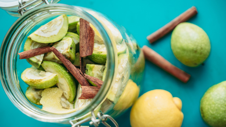 Green walnuts, cinnamon, lemon peel in jar