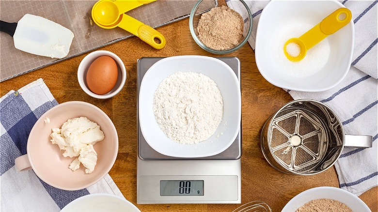 Food scale surrounded by baking ingredients 
